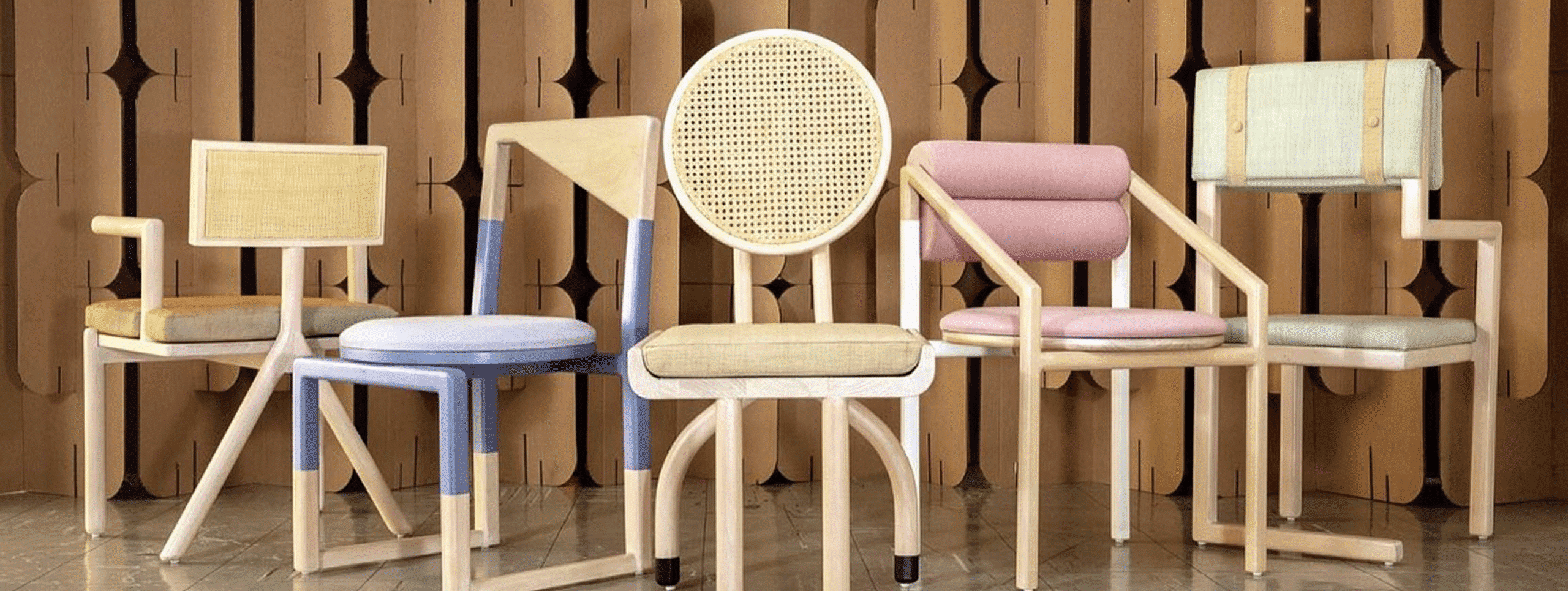 Colorful Zondçi chairs lined up against a patterned wood wall